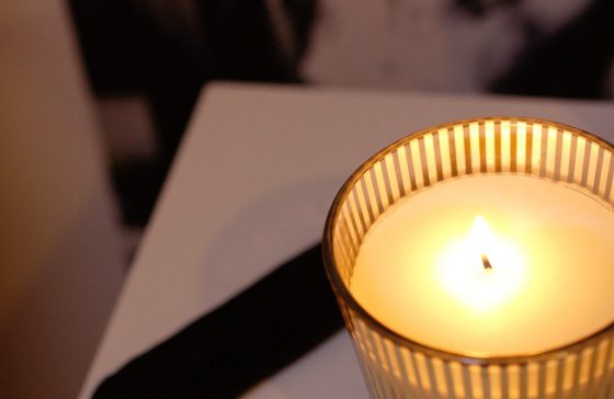 candle on a bedside table