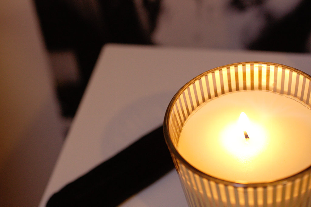 candle on a bedside table