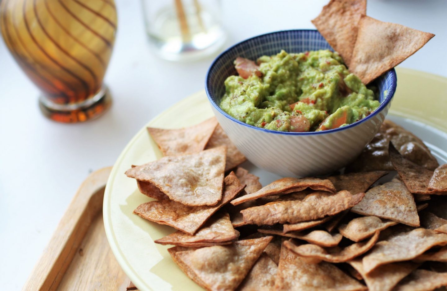 zoomed out shot of guacamole and tortilla chips