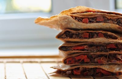 bean quesadillas, cut open and stacked on a tray