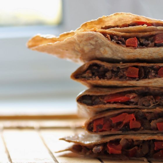 bean quesadillas, cut open and stacked on a tray