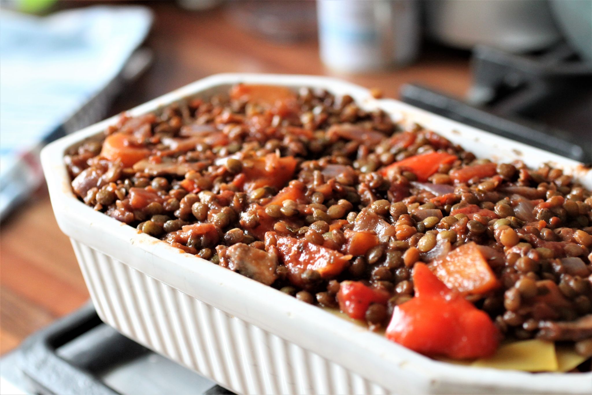 vegan lasagne being prepped, ragu in baking dish