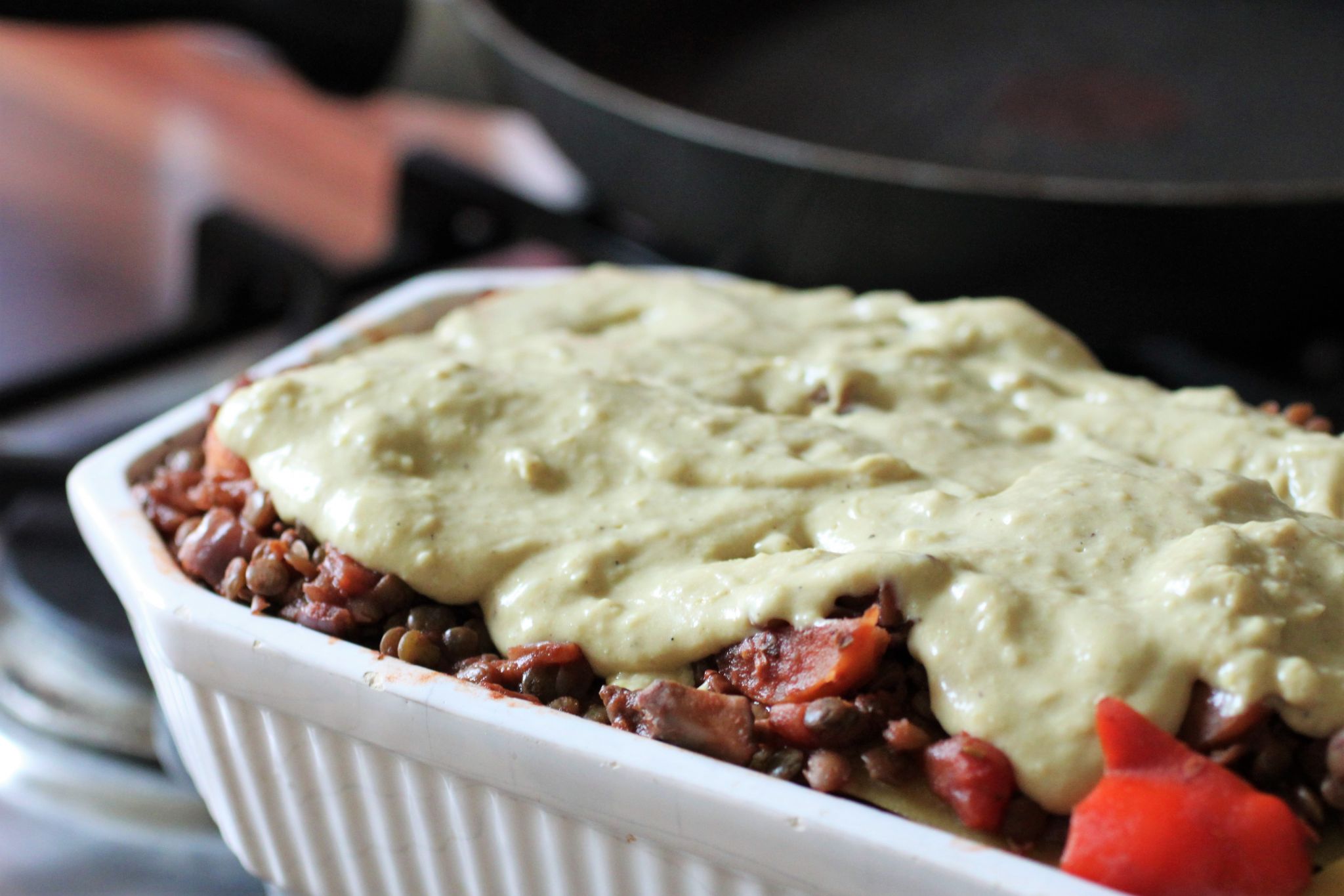 vegan lasagne before going in the oven, with the bechamel poured over
