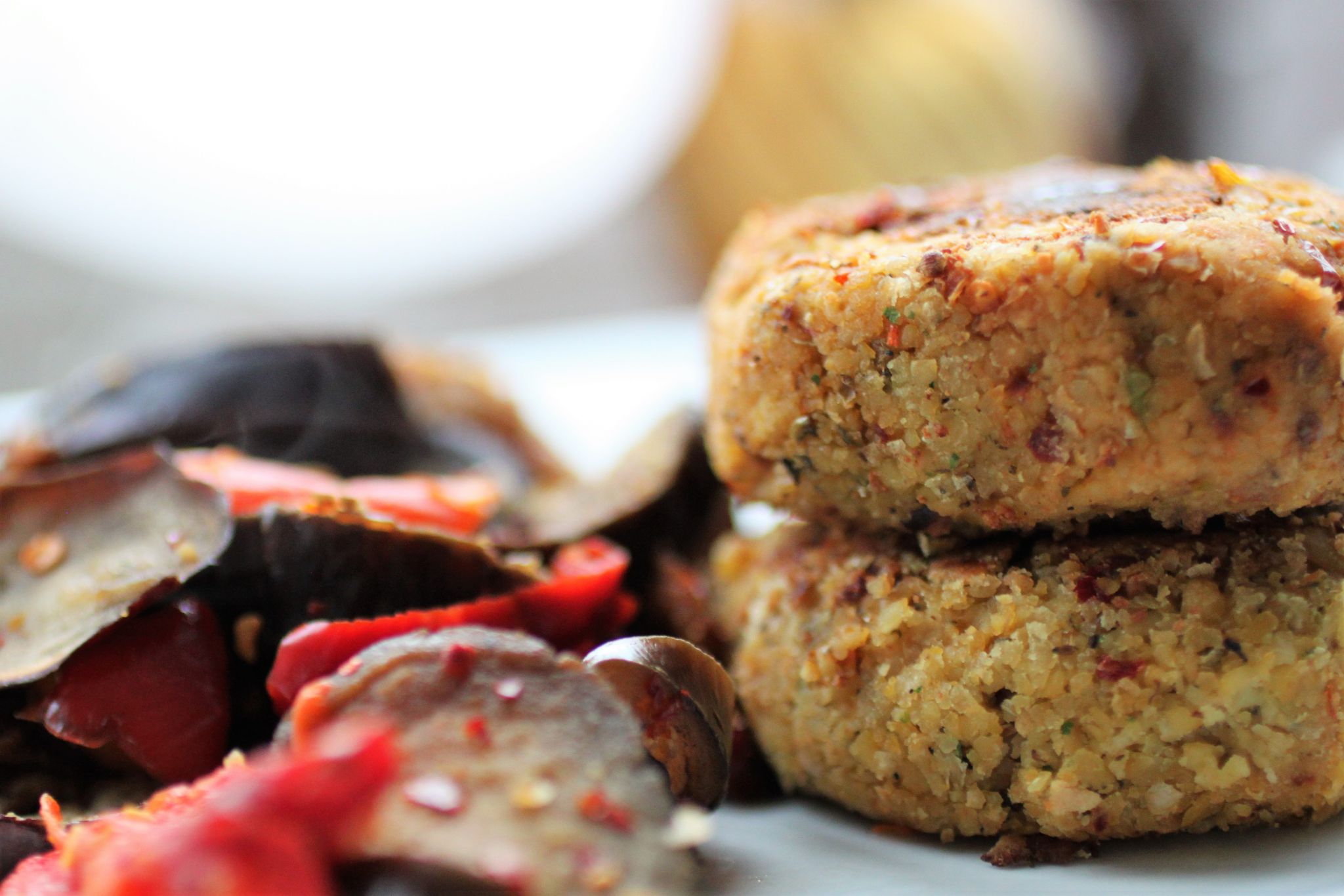 sundried tomato falafel from a side angle, on a white plate