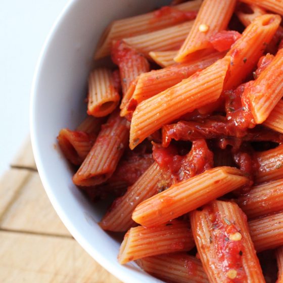 spicy basic tomato pasta sauce recipe in a white bowl close up, shot from above