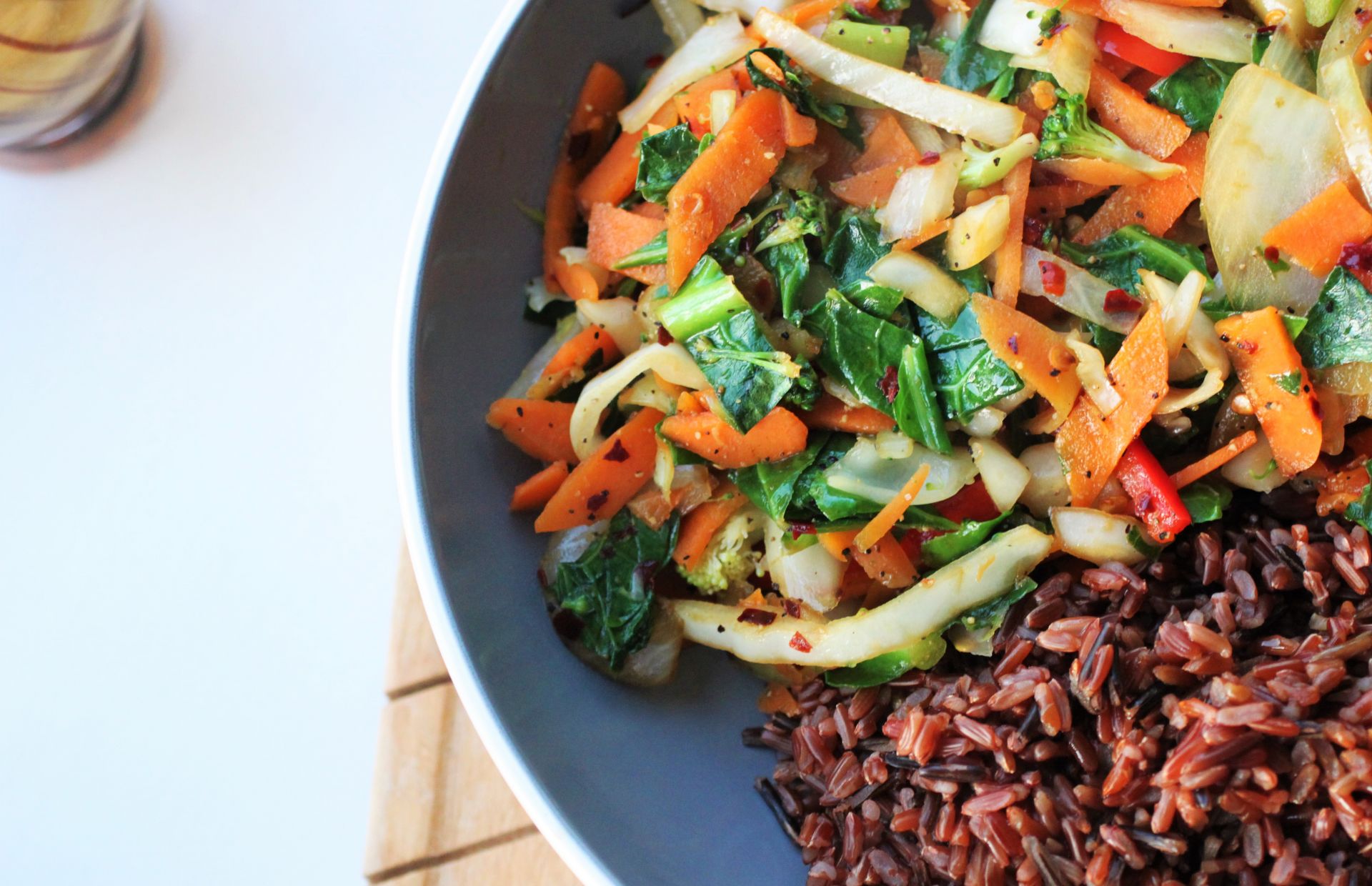 simple veggie stir fry recipe with red rice served in large pasta bowl