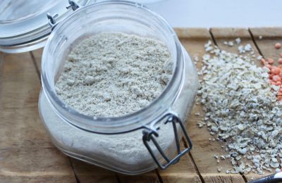 my favourite gluten free flours - open jar of oat flour on a wooden tray