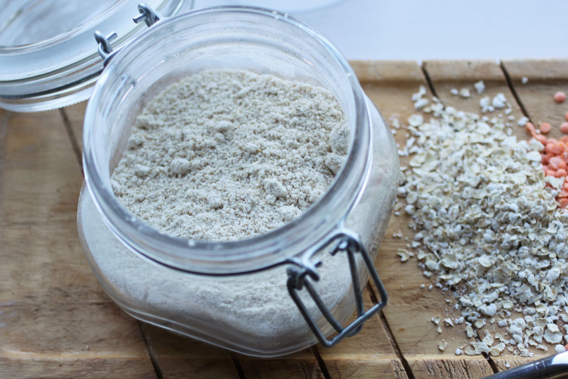 my favourite gluten free flours - open jar of oat flour on a wooden tray