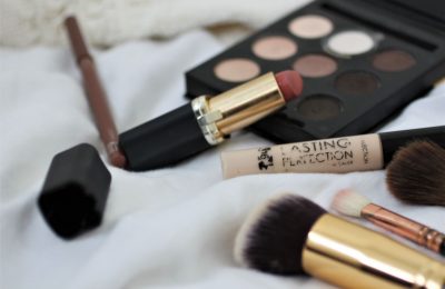 my nana picked my makeup products - makeup spread out over a white sheet