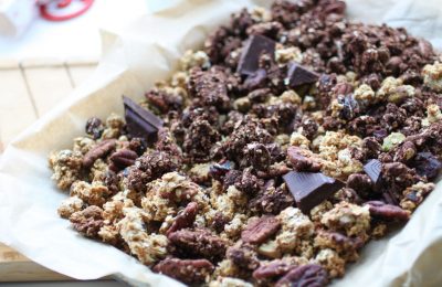 chocolate orange granola on a lined baking tray