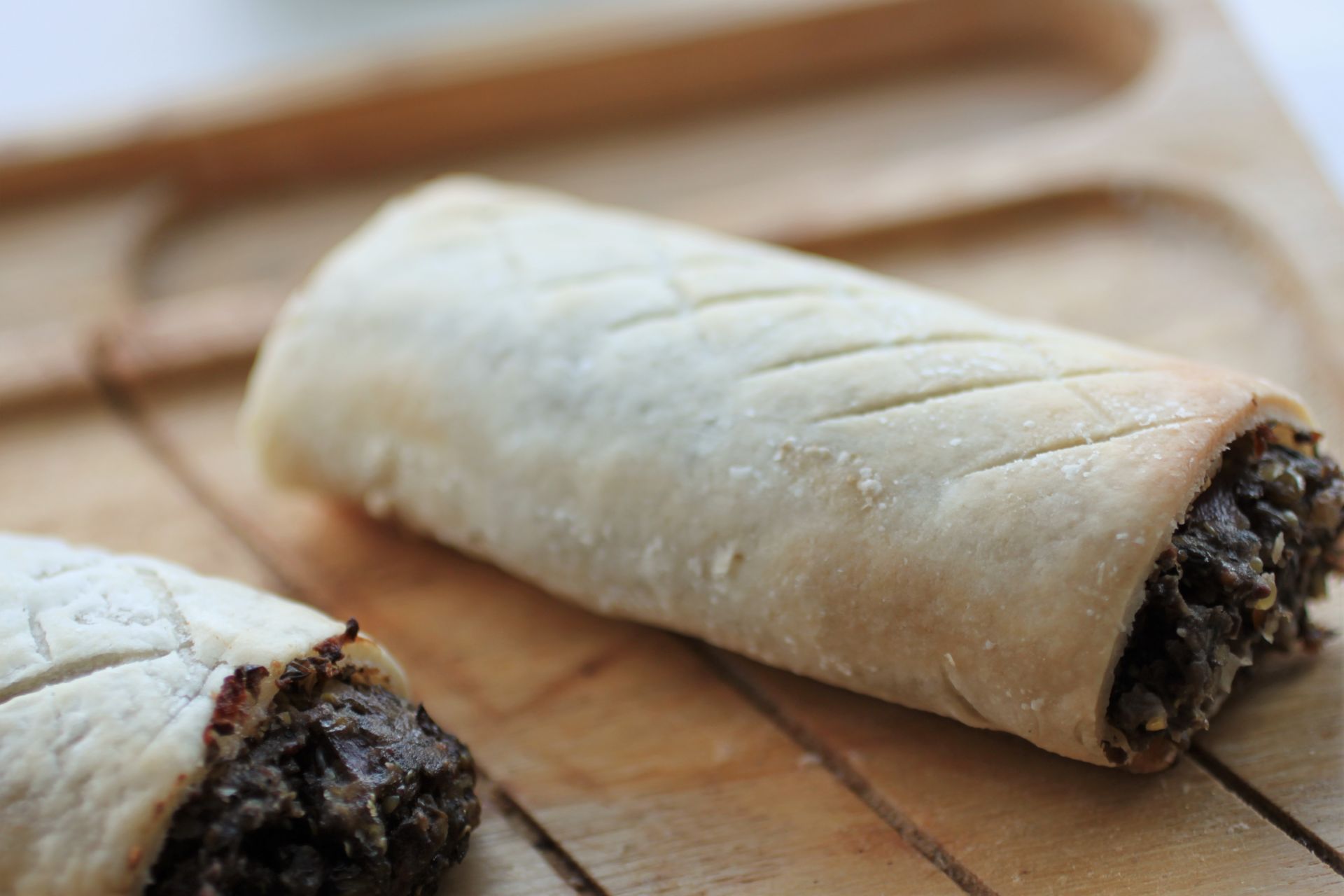 gluten free vegan sausaage rolls on a wooden tray