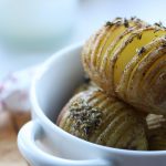 vegan hasselback potatoes in a white bowl