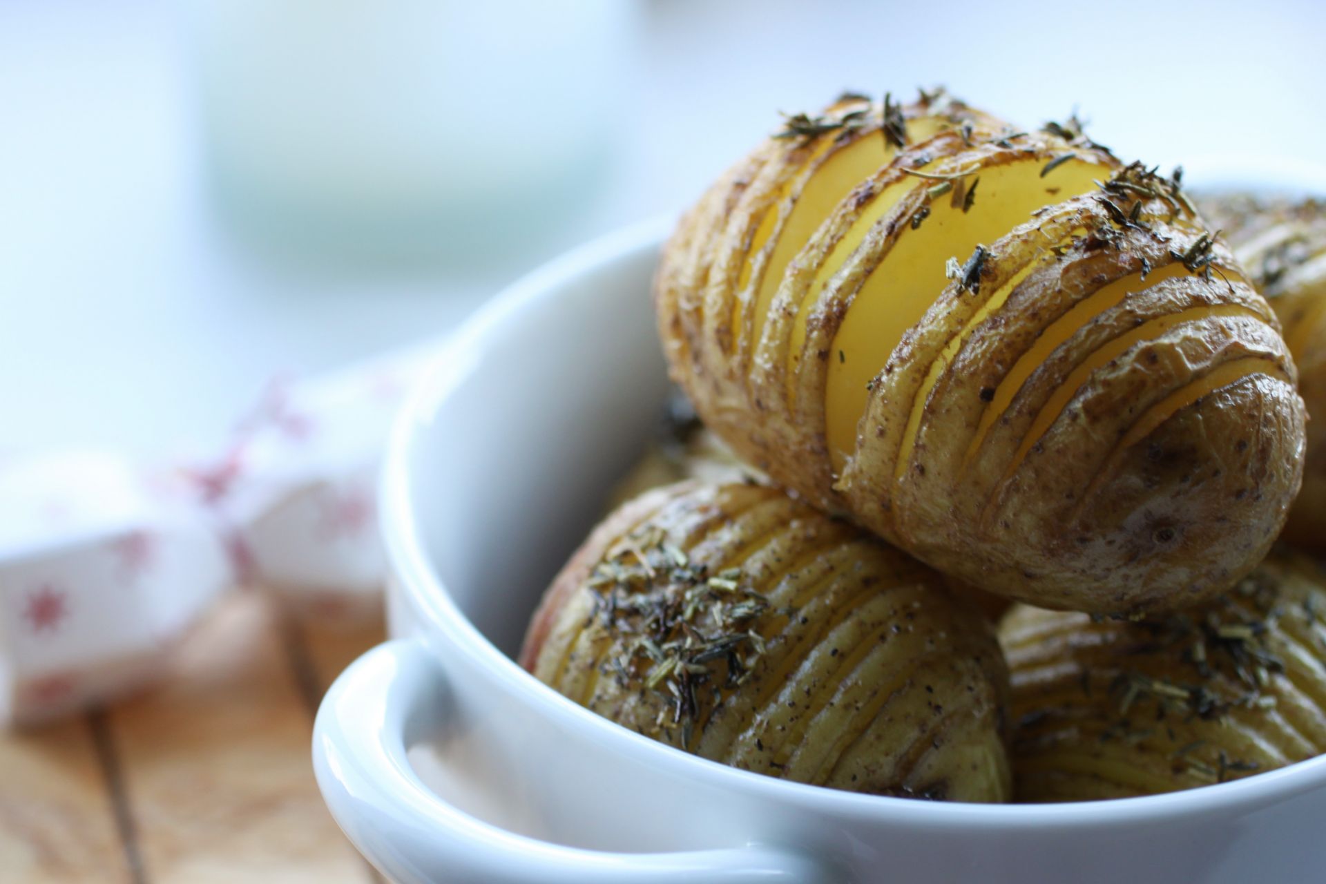 vegan hasselback potatoes in a white bowl