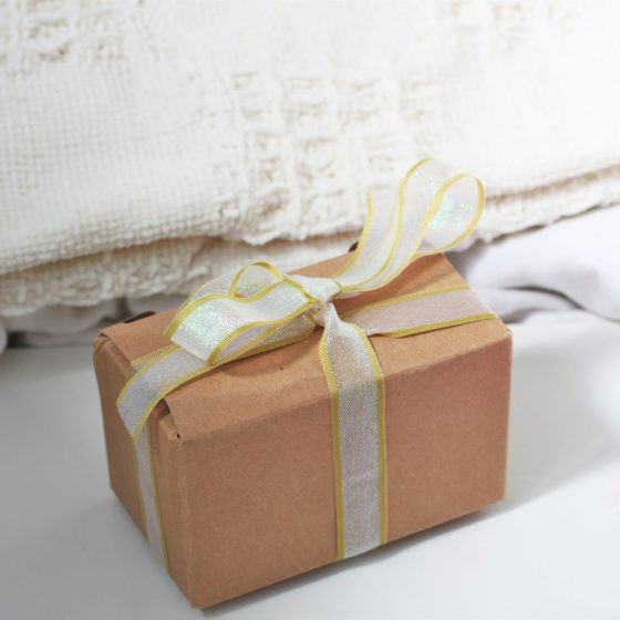 a small cardboard box tied with ribbon