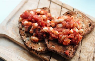 beans on toast on a wooden tray