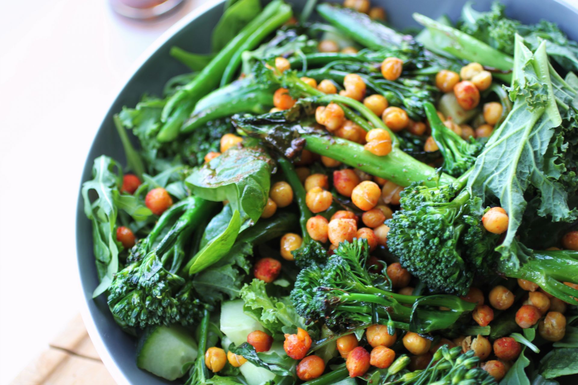 green salad recipe topped with roasted chickpeas in a large bowl