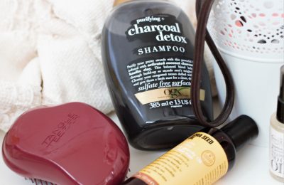 some hair products laid out on a white sheet
