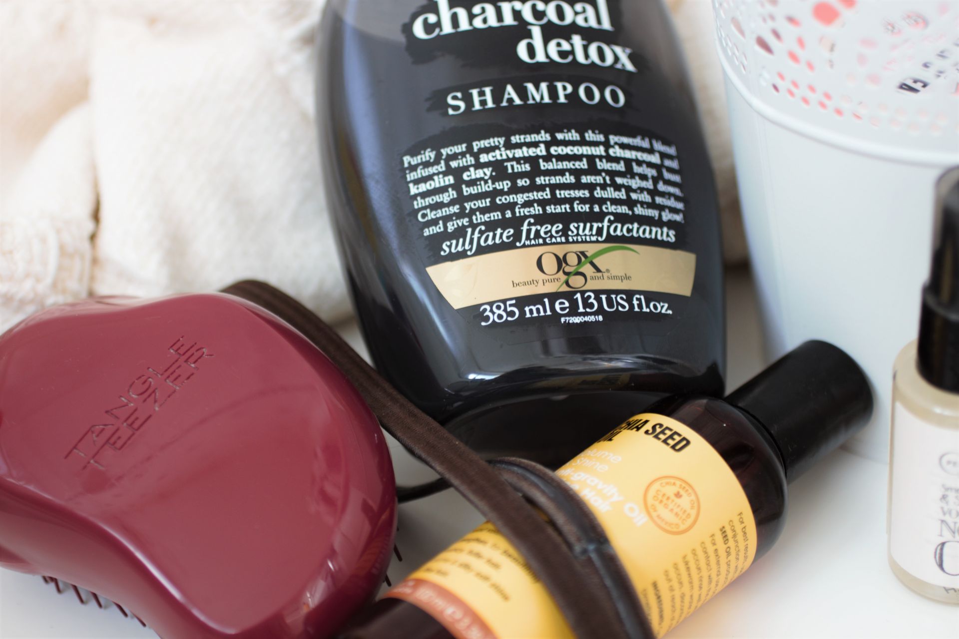 a selection of hair products I use on my curly hair on a white sheet