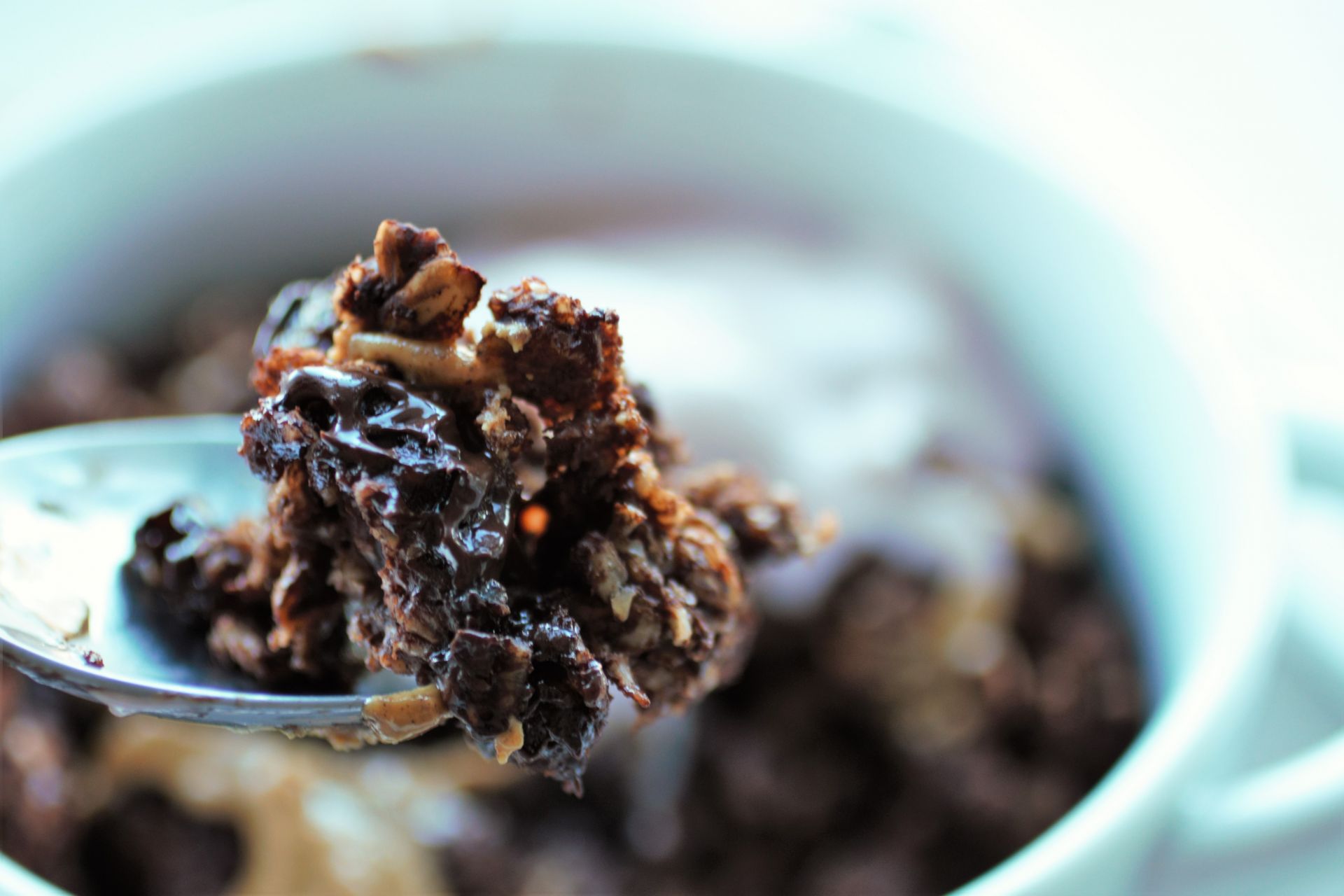 spoon showing the melted chocolate from the middle of the oats