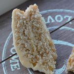two slices of vegan lemon & orange cake on a wooden tray