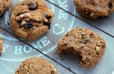 tray of carrot cake cookies, one with a bite taken from it