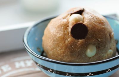 large cookie dough ball in a small blue bowl