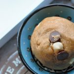 cookie dough recipe rolled into a ball and placed in a blue bowl, shot from above.