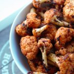 bowl of crispy baked cauliflower on a wooden tray