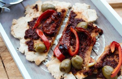 rustic gluten free flatbread sliced up on a wooden board