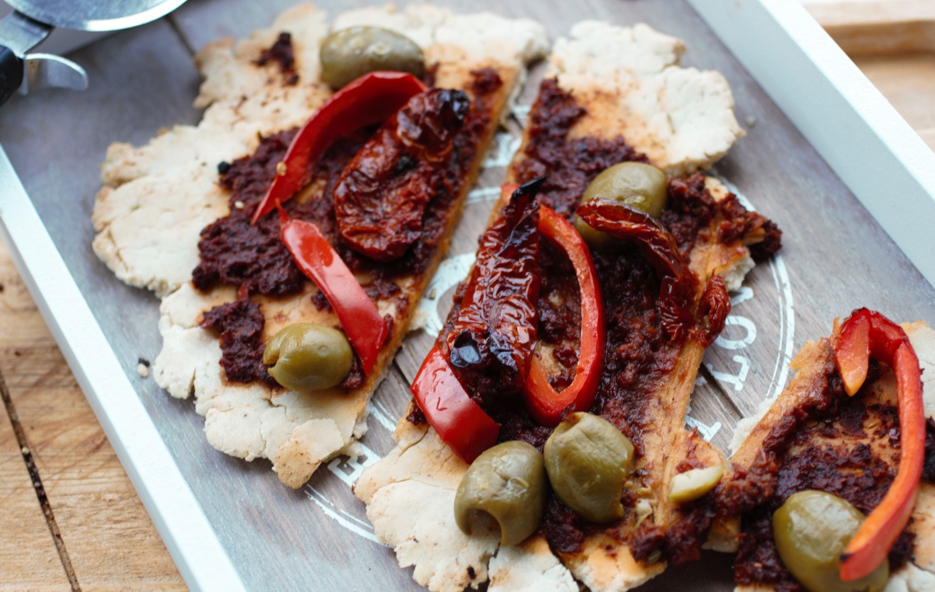 rustic gluten free flatbread sliced up on a wooden board