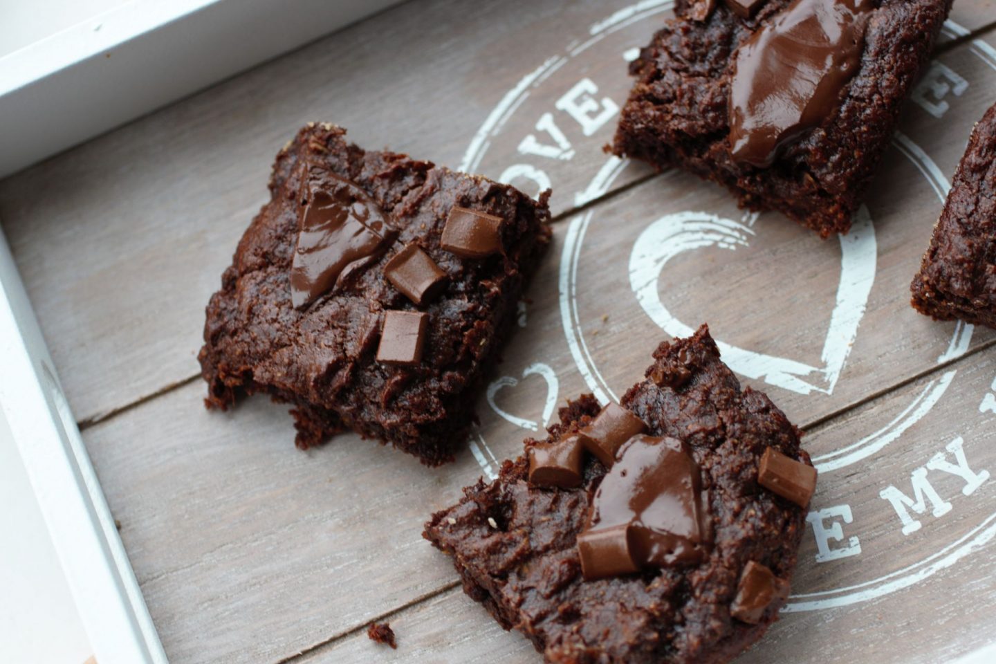 a grey wooden tray with some sliced sweet potato brownies on it