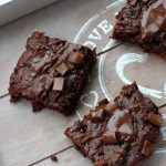 a grey wooden tray with some sliced sweet potato brownies on it
