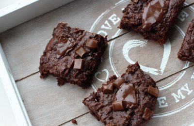 a grey wooden tray with some sliced sweet potato brownies on it