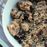 granola in a white bowl on a wooden tray
