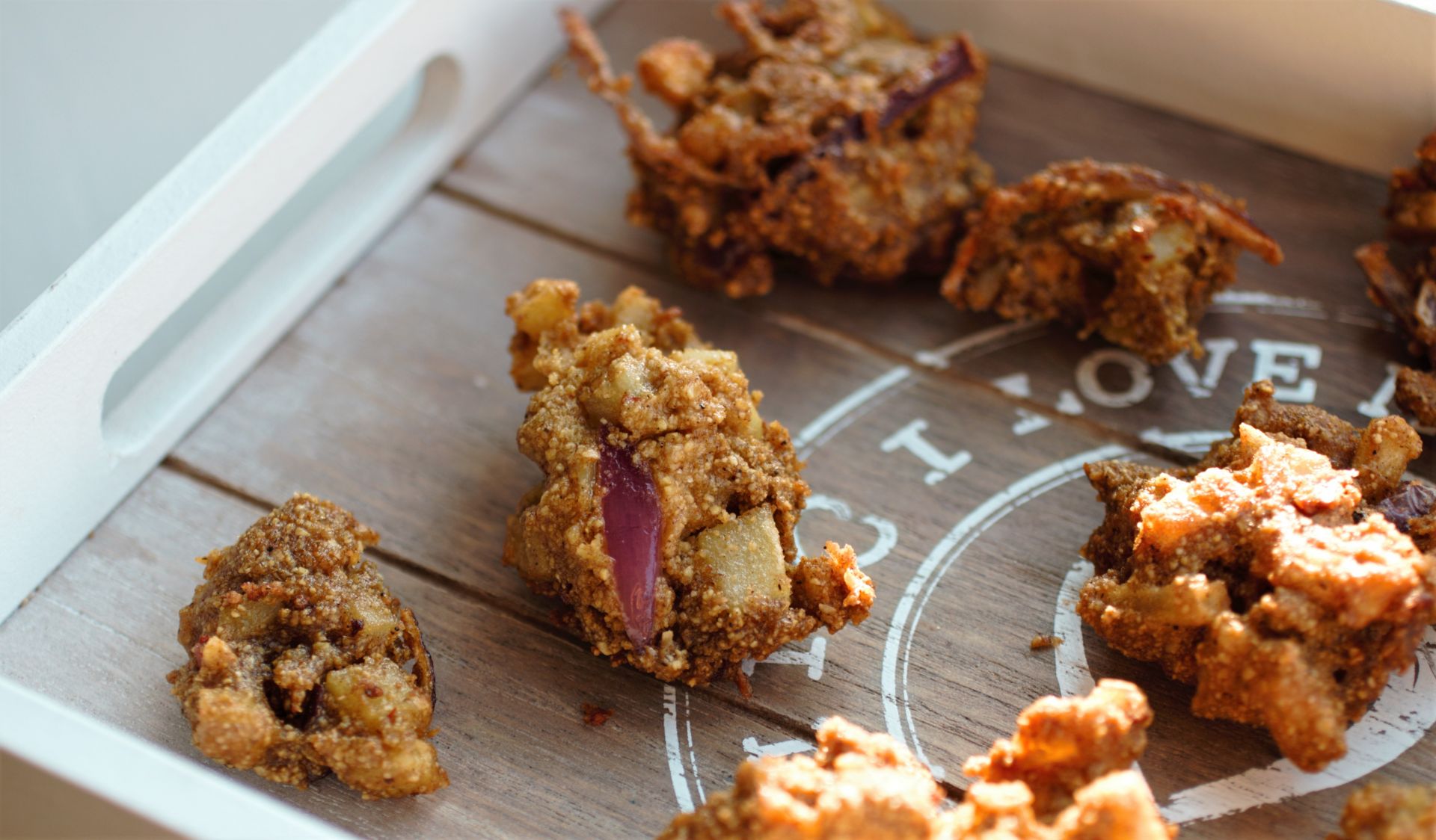 vegetable pakoras on a wooden tray