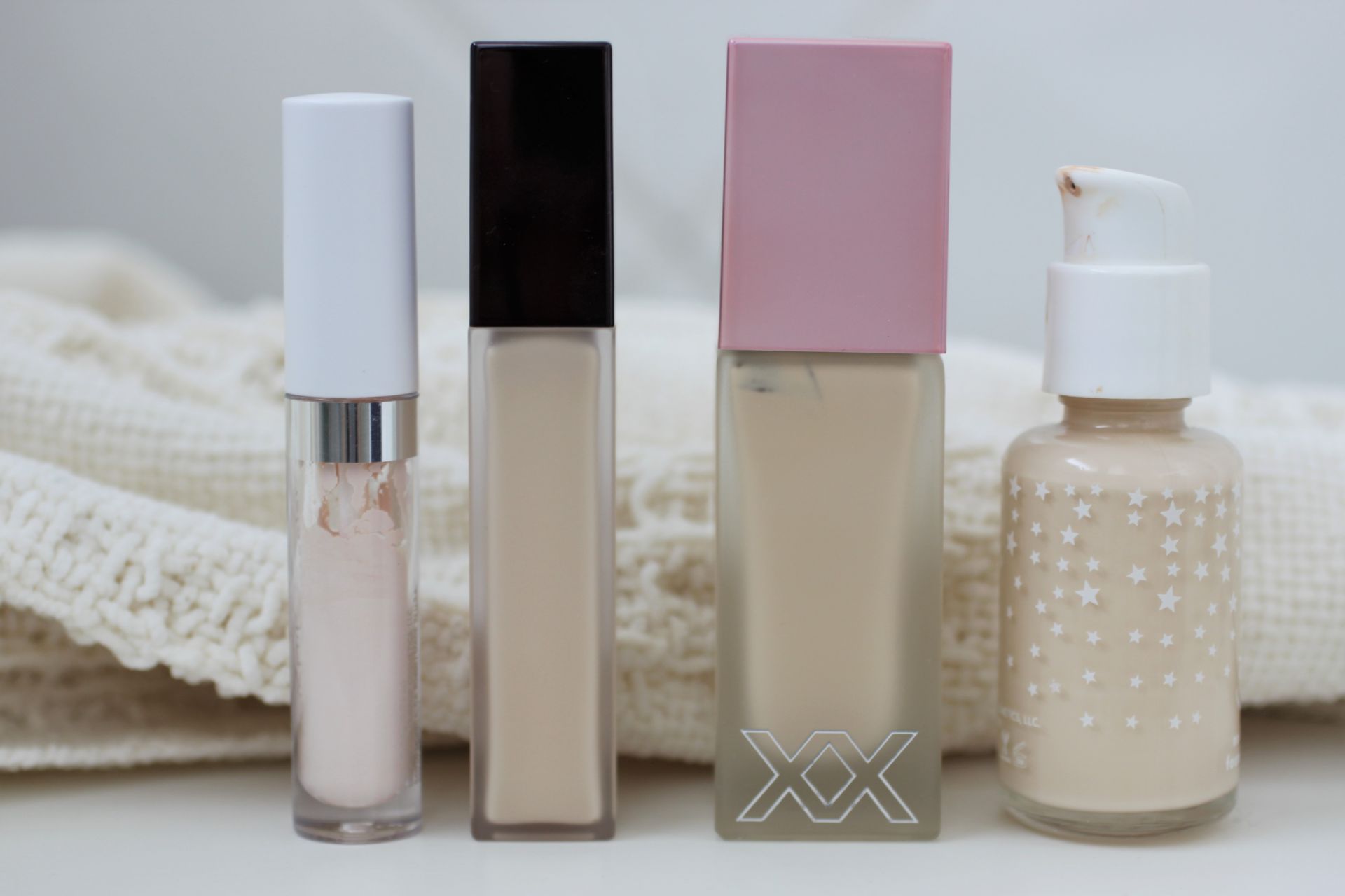 a few foundation and concealer bottles lined up