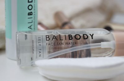 bali body face tan on its side next to some cotton pads