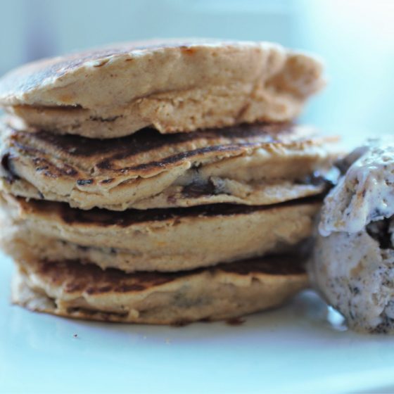 stack pf peanut butter choc chip pancakes on a white plate