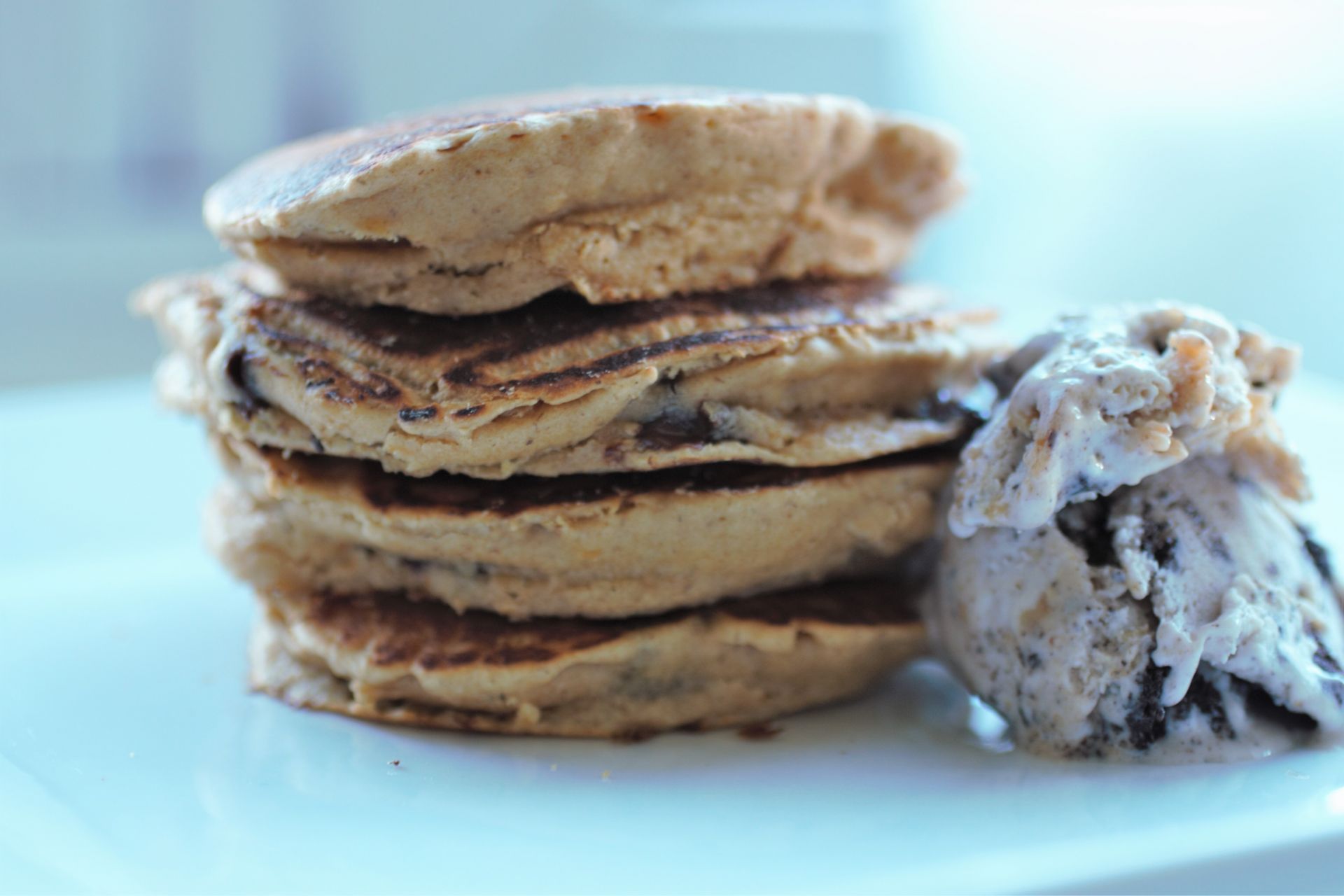 stack pf peanut butter choc chip pancakes on a white plate
