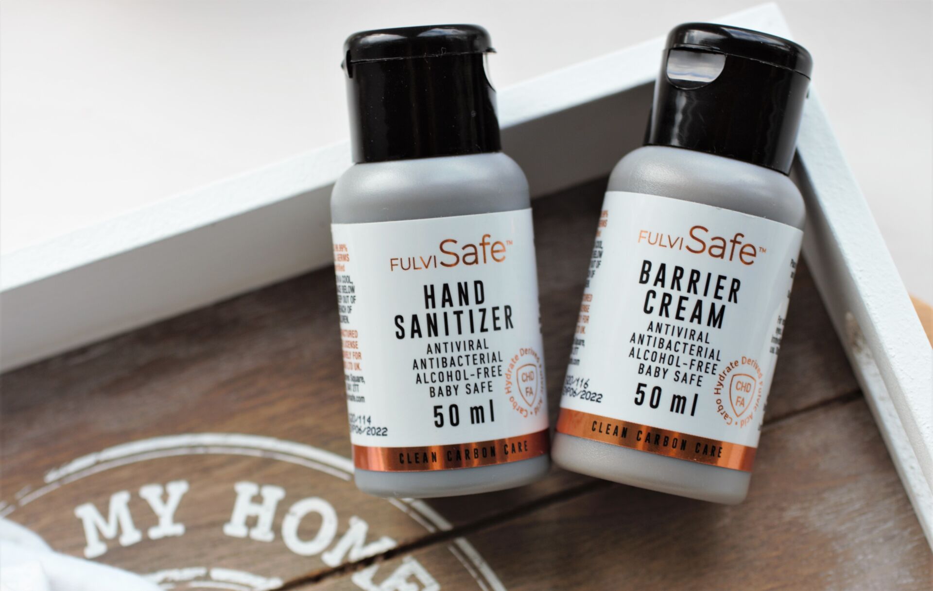 how to protect your hands from the coronavirus pandemic, alcohol free antiviral hand cream and sanitiser on a wooden tray