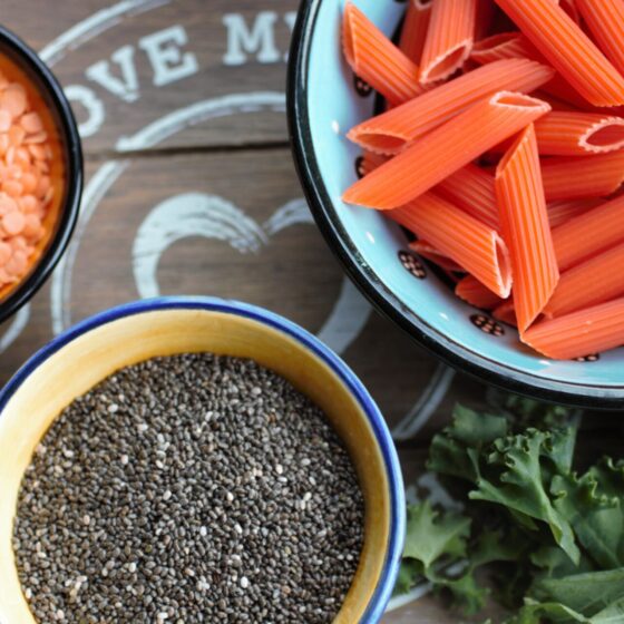 5 health foods in small bowls on a grey wooden tray