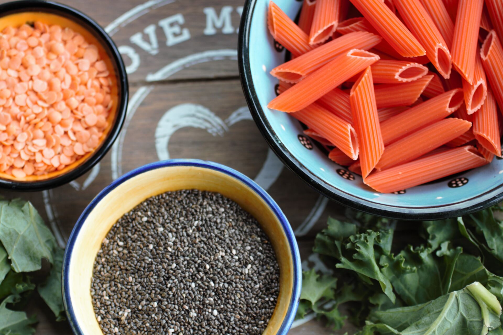 5 health foods in small bowls on a grey wooden tray