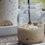 jar of bircher muesli with a spoon in