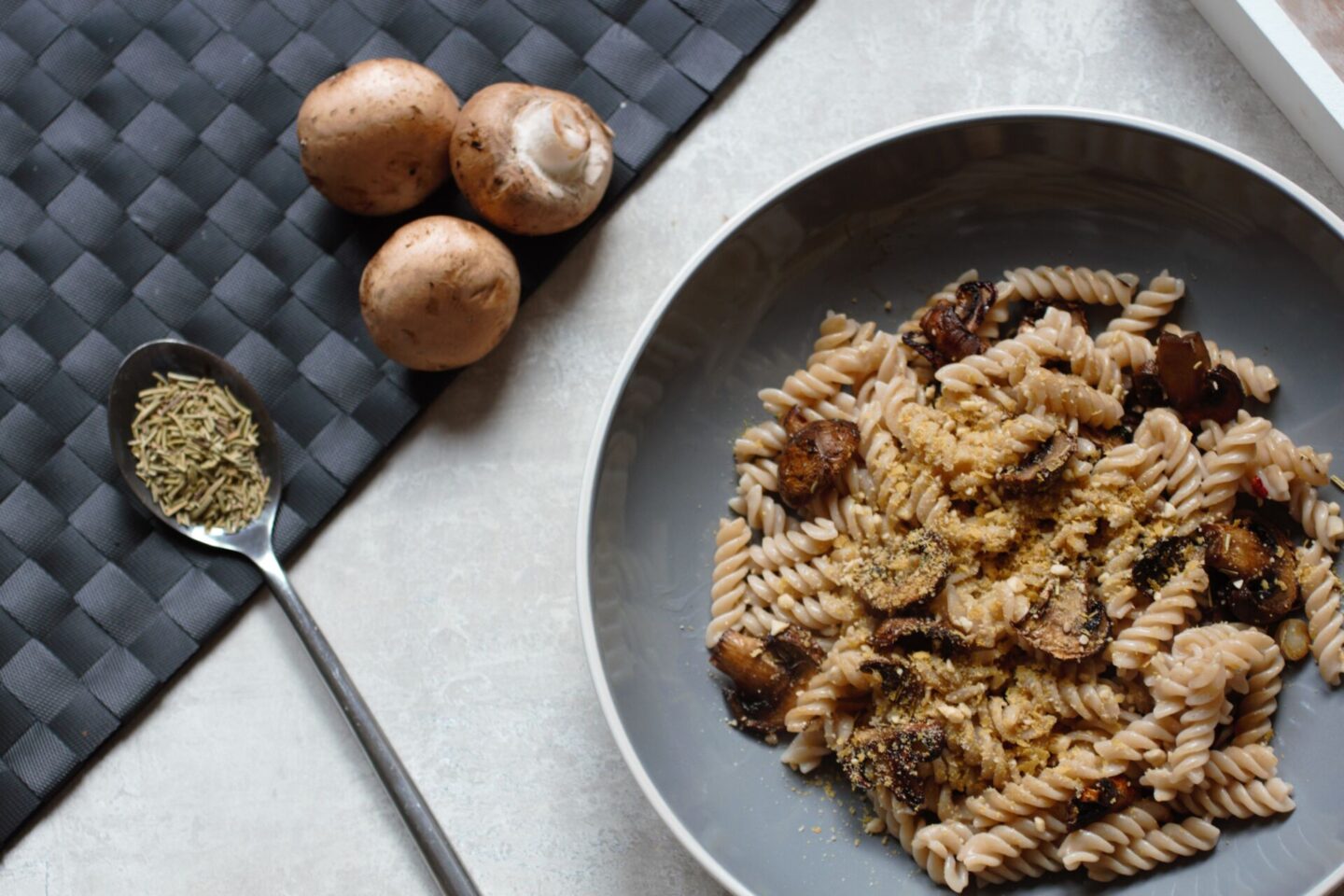 roasted mushroom pasta in a slate bowl