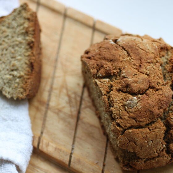 loaf shot from above, on a wooden bread board with one end sliced