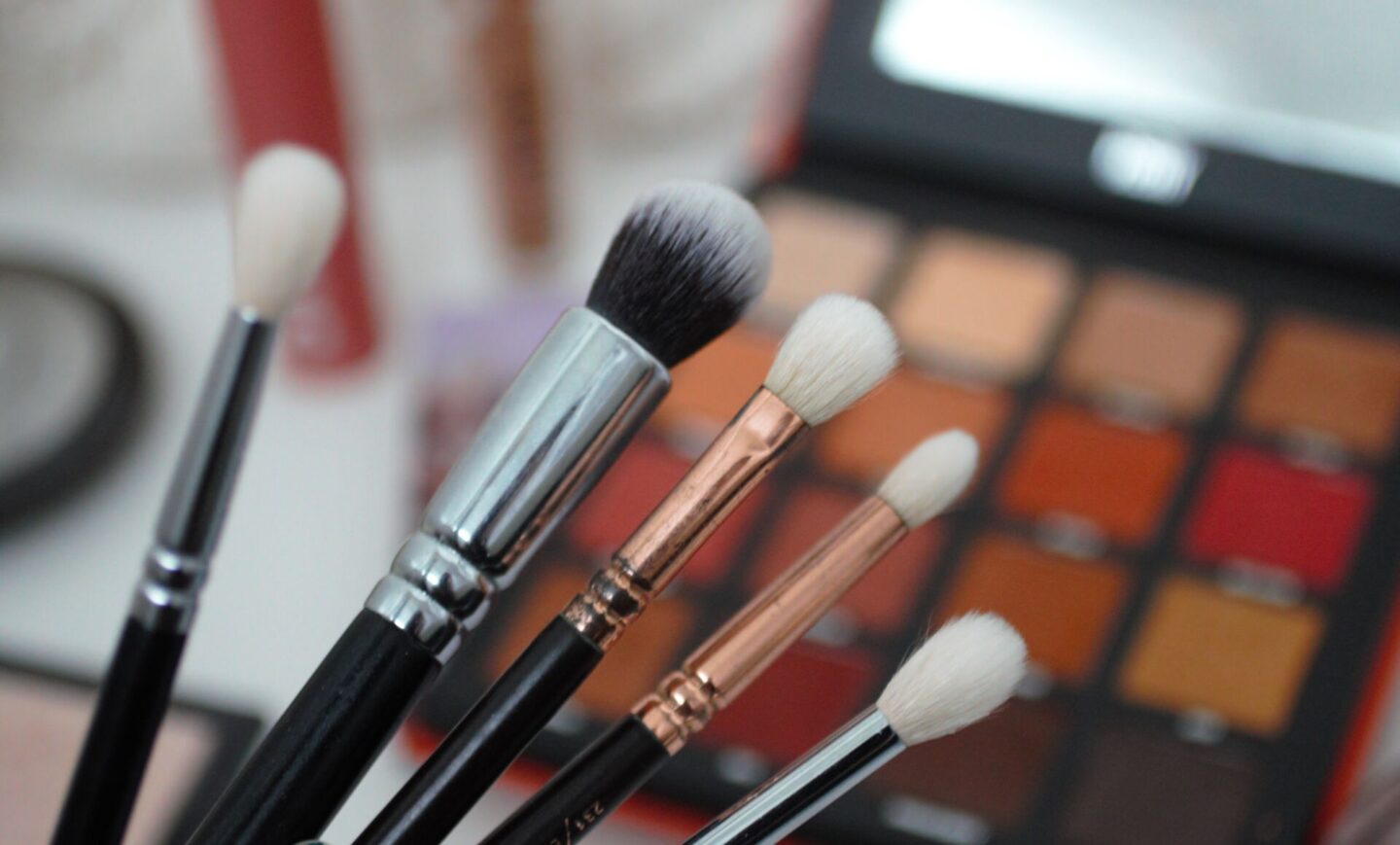 small selection of Zoeva brushes held over other makeup