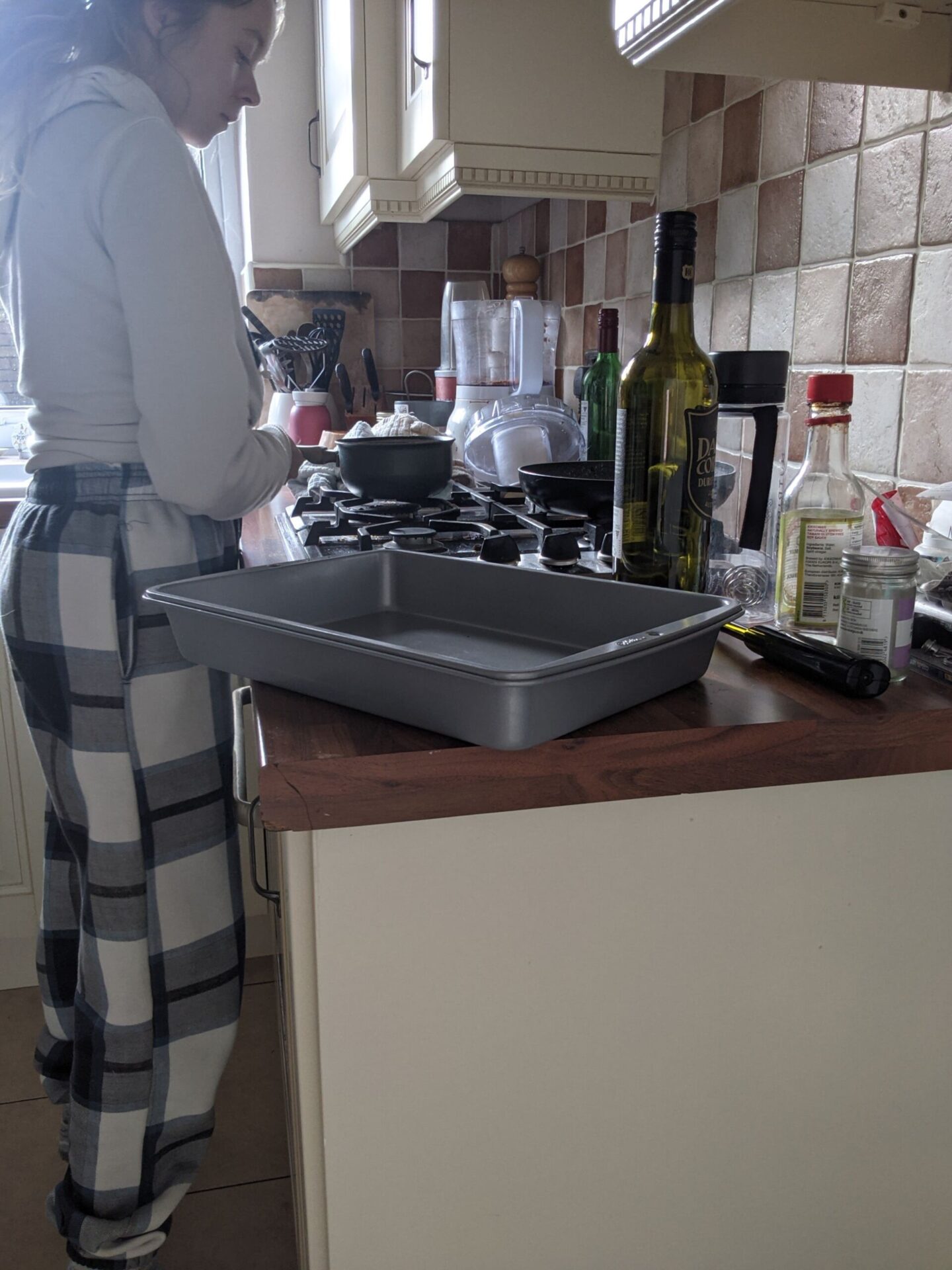 me stood in my messy kitchen in joggers and a sweater