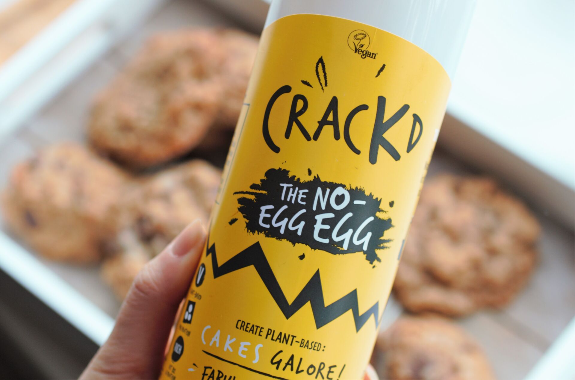 me holding a bottle of cracked over a tray of cookies