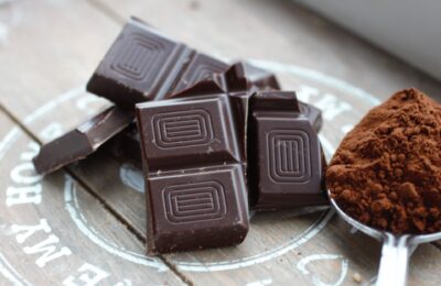 dark chocolate and cocoa powder on a grey tray