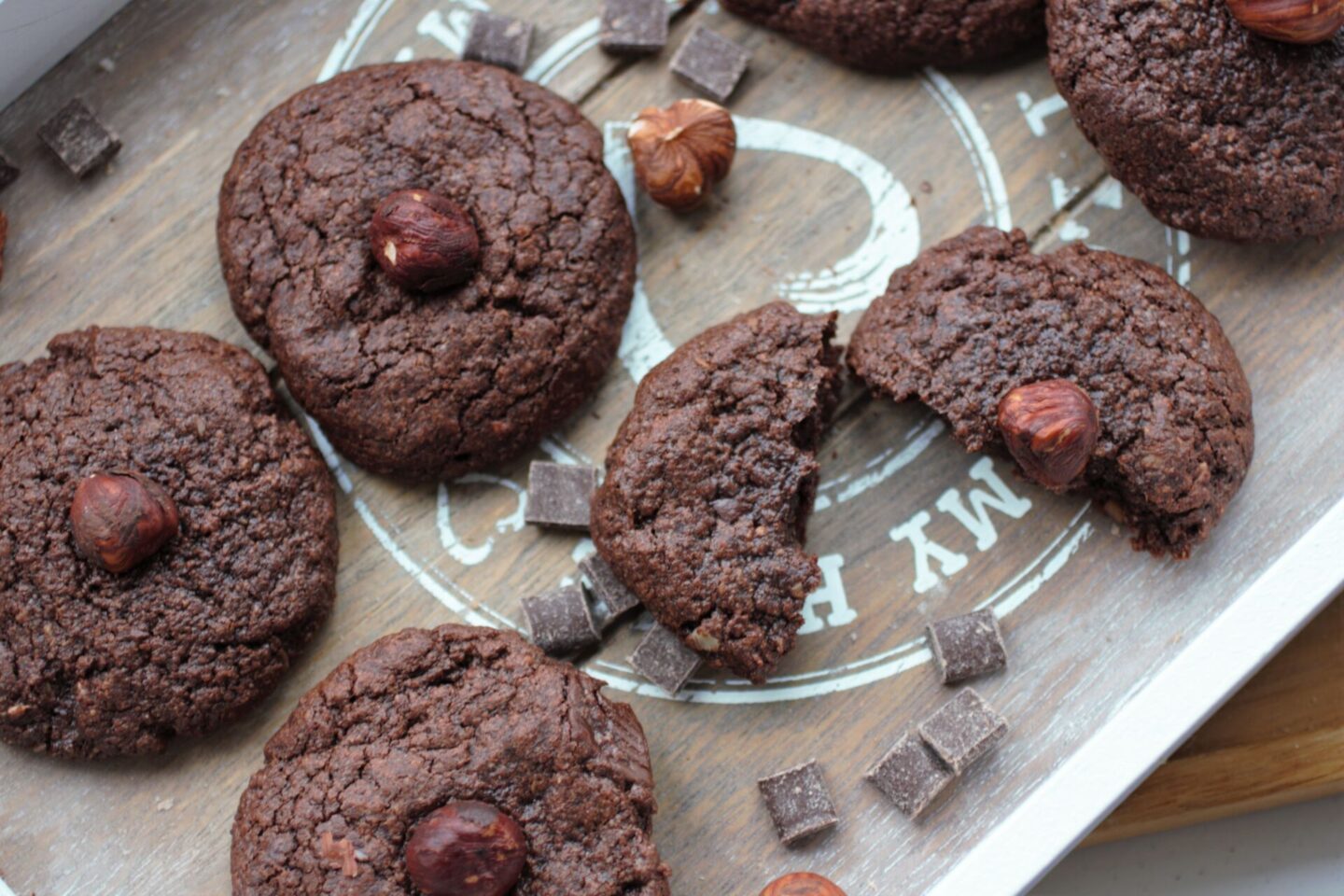 nutella cookies on a tray with some chocolate chips and hazelnuts